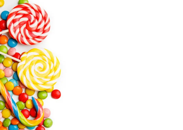 Colorful candies and lollipops isolated on white background — Stock Photo, Image