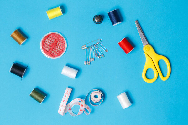 Sewing Kit Scissors Pins Spools of Thread Flatlay