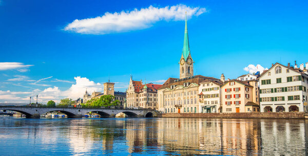 View of historic Zurich city center with famous Grossmunster Church and lake