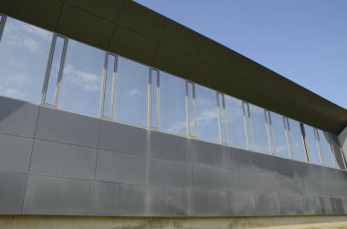 Modern binaların önündeki çimlerin üzerindeki ağaçlar