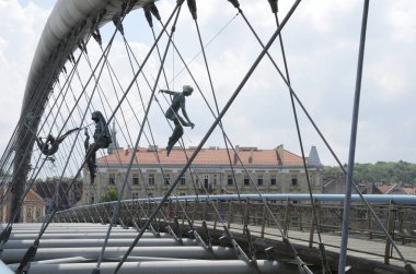 Krakow, Poland - July 27, 2018: Sculptures on bridge over Vistula River,  that joins Kazimierz, the Jewish quarter, with Podgorze, the Jewish ghetto in krakow, Poland.