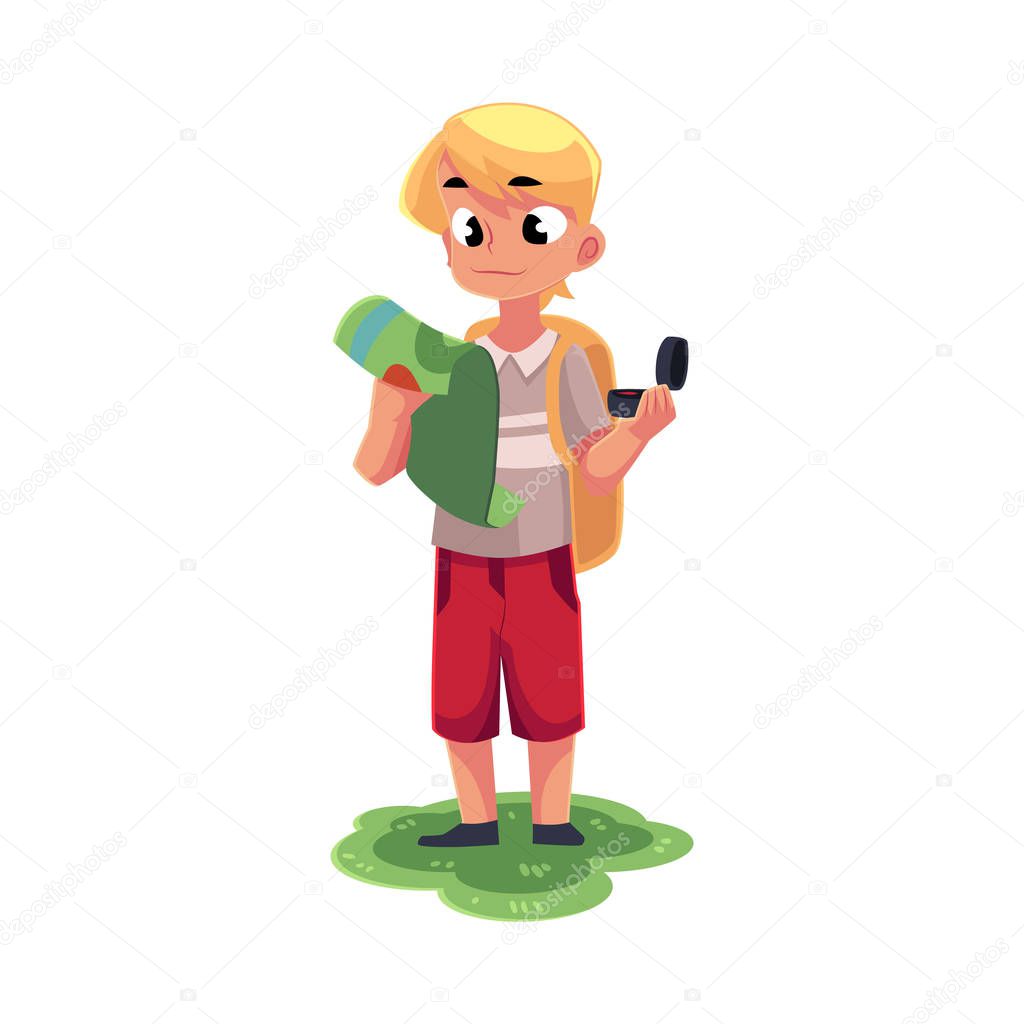 Teenage Caucasian boy with a backpack studying map, holding compass