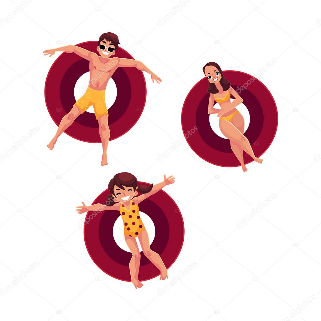 Caucasian woman, man and little girl floating on inflatable rings