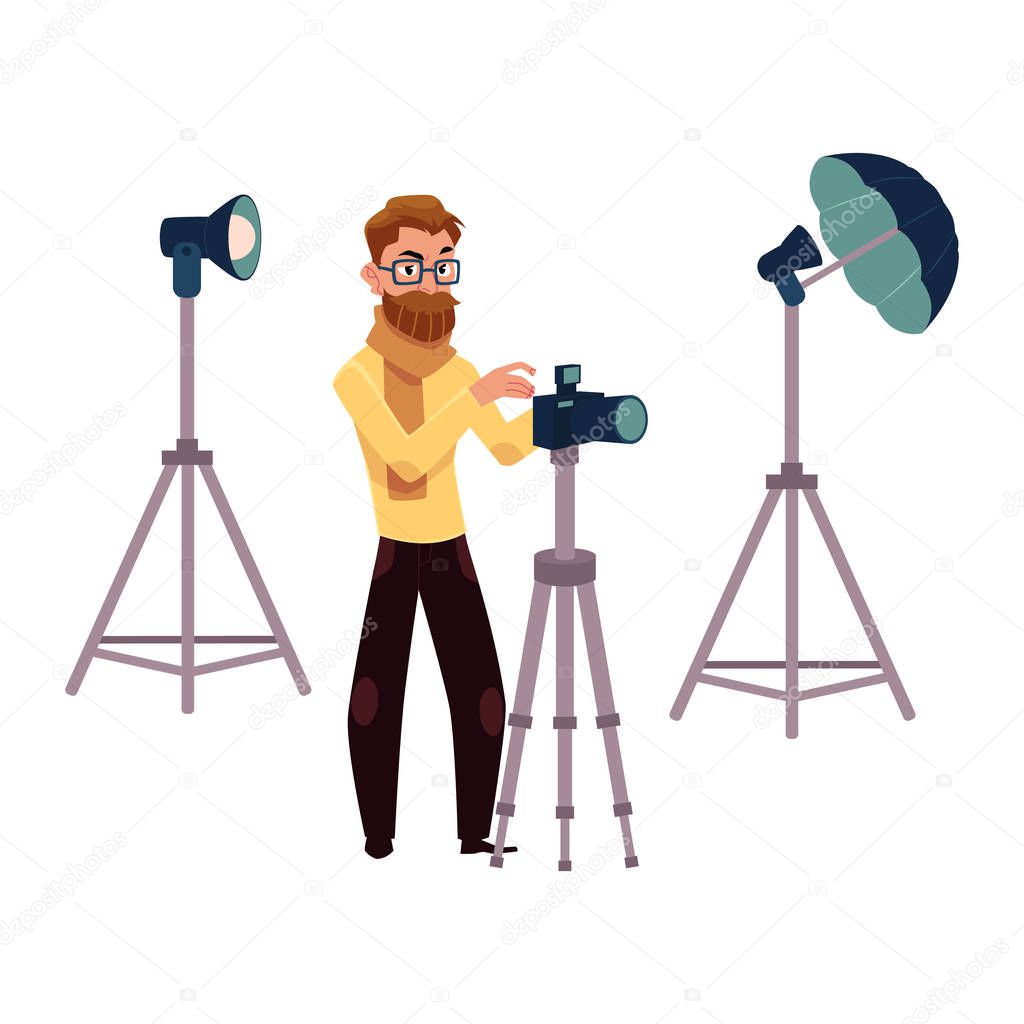 Male photographer taking pictures, shooting in studio and photo equipment