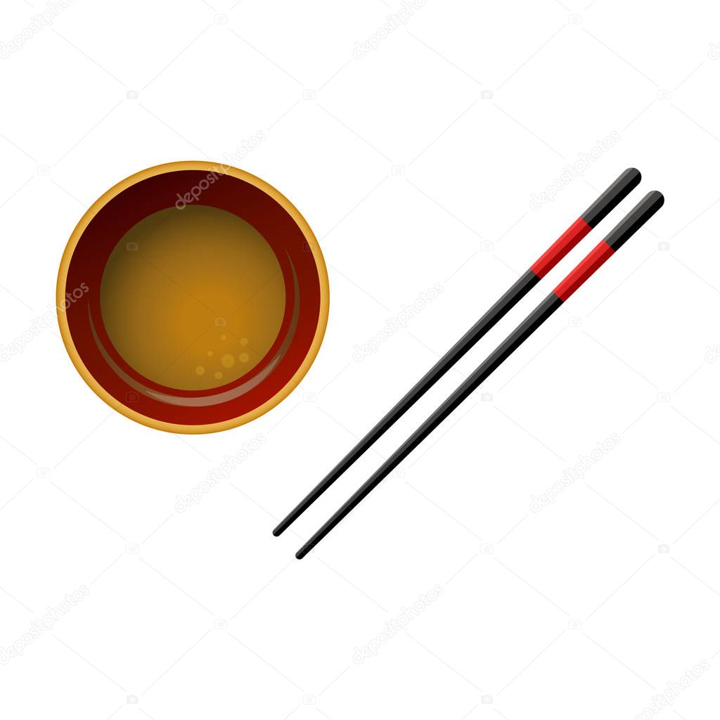 Pair of black wooden chopsticks with red lines and bowl with soy sauce isolated on white background.