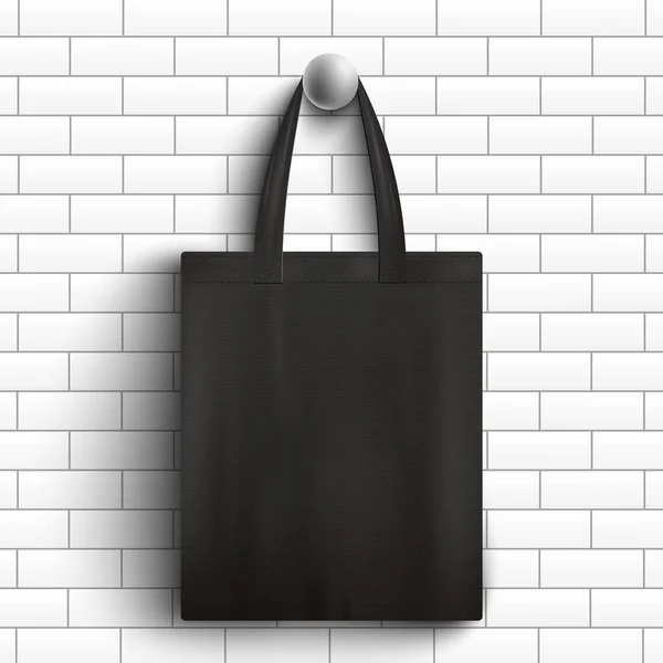 Beyaz tuğla duvarda asılı siyah kumaş çanta - gerçekçi marka modeli — Stok Vektör