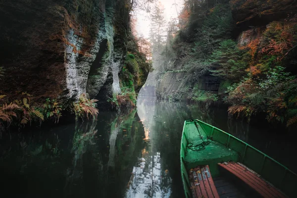 River in the mountains. The boat on the water. Autumn