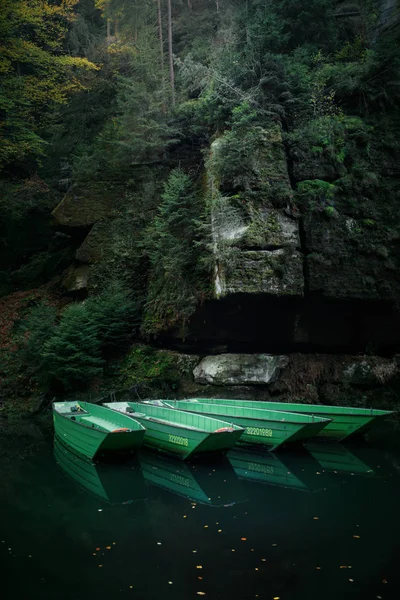 River in the mountains. The boat on the water. Autumn