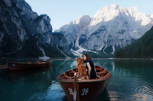 Women and dog in a boat on a mountain lake. Traveling with a pet to Italy. girl with Dog — Stock Photo, Image