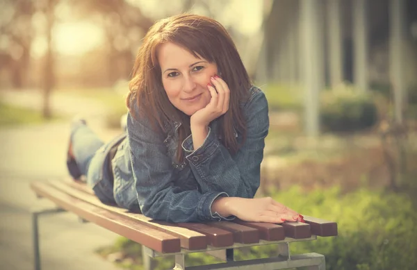 Femme mignonne se détendre sur le banc — Photo