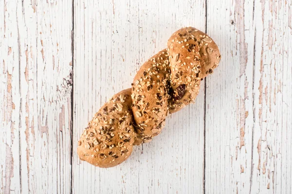 Fresh seedy bread on white wooden background — Stock Photo, Image