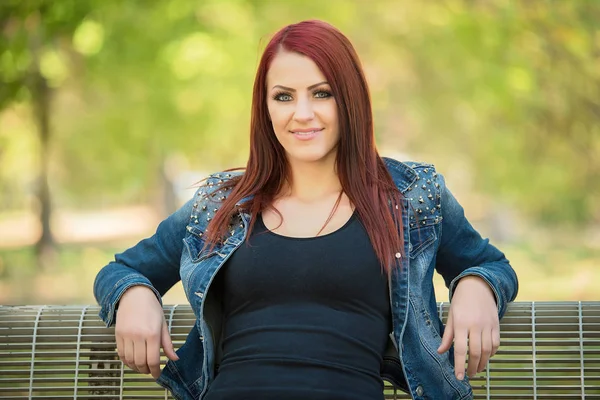 Charming woman sitting on bench in the nature Royalty Free Stock Images