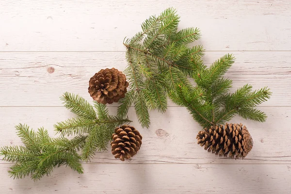 Pine branch and cone on wooden background — Stock Photo, Image