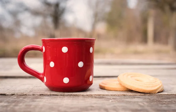Chá Escuro Uma Caneca Bolinhas Vermelhas Com Biscoito Uma Mesa — Fotografia de Stock