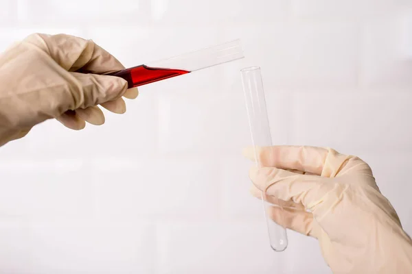 Laboratory technician working with test tube in laboratory. Detail photo