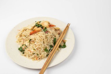 Homemade fish sauce fried bee hoon with few fresh prawn and vegetable on white background. clipart