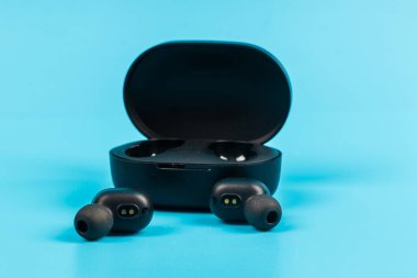 Mavi arkaplanda kablosuz bluetooth kulaklık var.