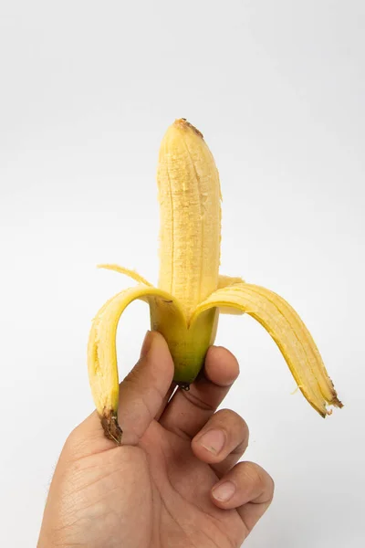 Χέρι Ανθρώπου Ώριμες Αποφλοιωμένες Μπανάνες Λευκό Φόντο — Φωτογραφία Αρχείου