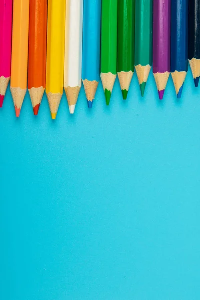 portrait of set of colorful pencils on blue background with copy space