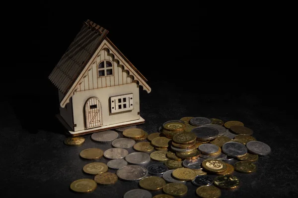 coin stack with house model saving money for buying house property. real estate investment finance and banking