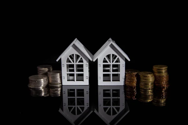 coin stack with house model saving money for buying house property. real estate investment finance & banking