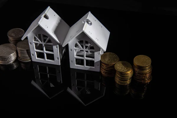 coin stack with house model saving money for buying house property. real estate investment finance & banking