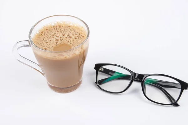 Cup of coffee and eye glasses are isolated on white background