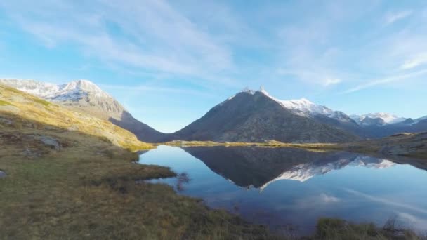 カラフルな落日にフェージング高度風景を移動する雲の 4 k のタイムラプス ビデオ。雪を頂いた山脈は、牧歌的な高山湖に反映されます。イタリア フランス アルプス. — ストック動画