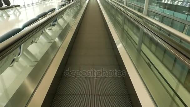 Sliding airport travelator. Walking fast on moving walkway. Subjective view. — Stock Video