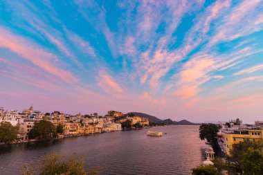 Udaipur cityscape batımında renkli gökyüzü ile. Göl PICHOLA, seyahat hedef, Rajasthan Hindistan görkemli şehir sarayının