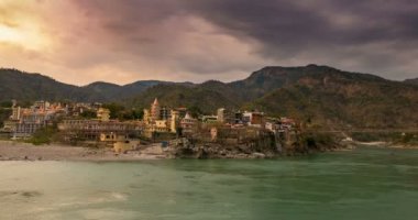 Zaman atlamalı Rishikesh, kutsal şehir, alacakaranlıkta ve hedef Hindistan'da seyahat. Renkli gökyüzü ve Ganj Nehri üzerinde hareketli bulutlar. 