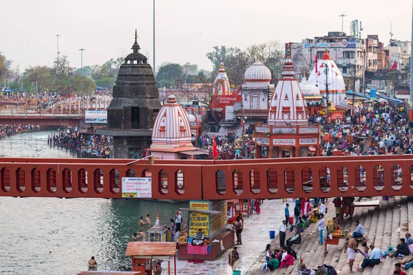 Haridwar, Índia - 20 de março de 2017: Santos ghats e templos em Haridwar, Índia, cidade sagrada para a religião hindu. Peregrinos rezando e tomando banho no rio Ganges . — Fotografia de Stock