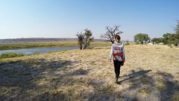 Tourist walking in nature reserve on the Chobe River, Namibia Botswana border, Africa. Chobe National Park, famous wildlilfe reserve and upscale travel destination. — Stock Video