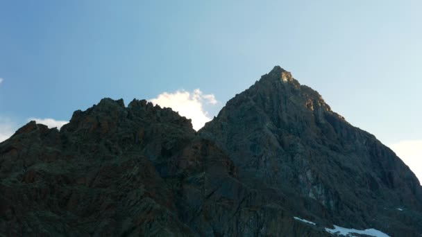 Cumes de montanhas cobertas de neve e picos com nuvens em movimento sobre os Alpes no verão, Província de Torino, Itália. Tempo de desvanecimento da luz solar para o crepúsculo . — Vídeo de Stock