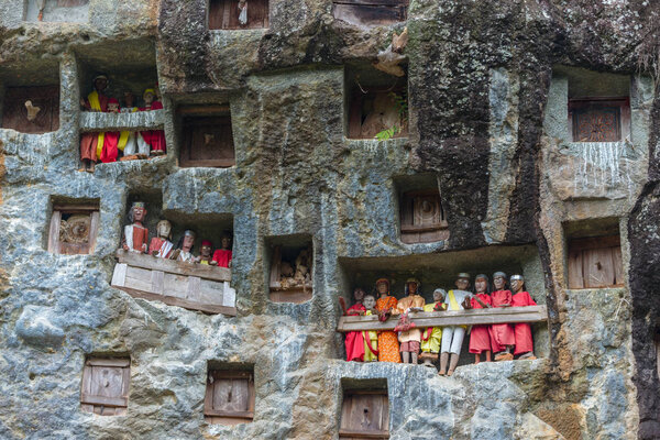 Lemo (Tana Toraja, South Sulawesi, Indonesia), famous burial site with coffins placed in caves carved into the rock, guarded by balconies of dressed wooden statues, images of the dead persons (called 