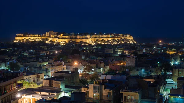 stock image Glowing cityscape at Jodhpur at dusk. The majestic fort perched on top dominating the blue town. Scenic travel destination and famous tourist attraction in Rajasthan, India.