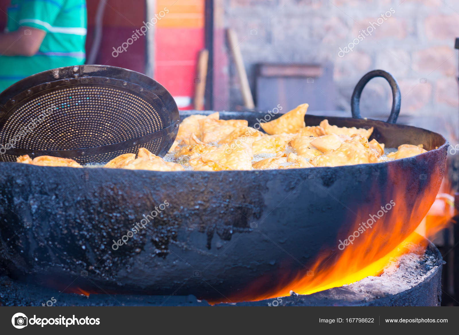Cooking and deep frying in fatiscent big pan or wok, street food