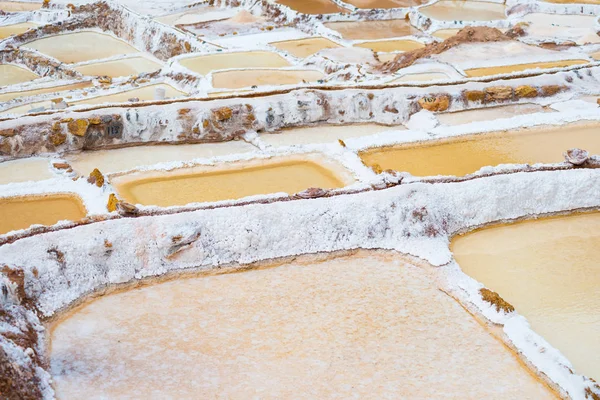 Panelas de sal com terraço também conhecidas como "Salineras de Maras", entre os destinos de viagem mais pitorescos da região de Cusco, Peru. Vista de cima das superfícies refletoras das lagoas coloridas . — Fotografia de Stock