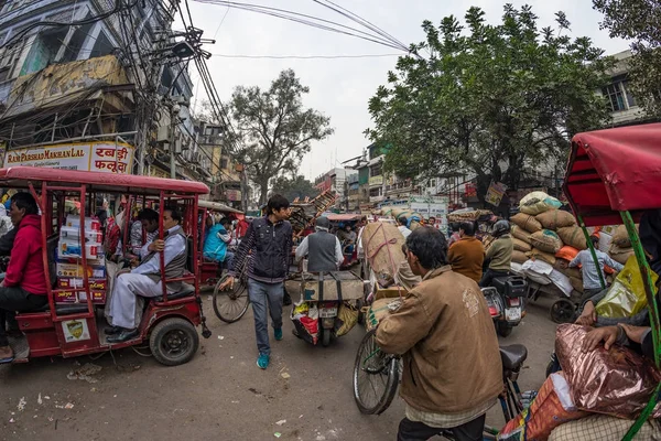 Delhi, India - December 11, 2017: crowd and traffic on street at Chandni Chowk, Old Delhi, famous travel destination in India. Chaotic city life, working people, fisheye ultra wide view. — Stock Photo, Image