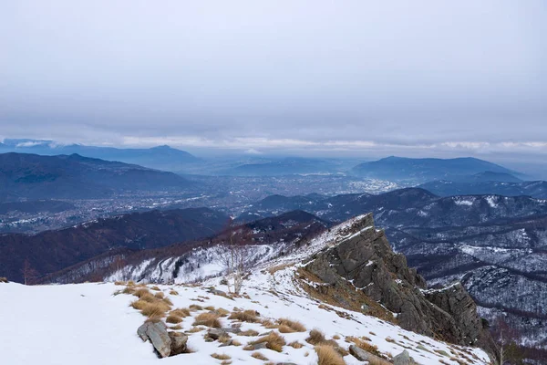 Vinterlandskap, alpin dalen och snöklädda bergskedjan, moln mulet mörka. — Stockfoto