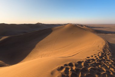 Namib Çölü, kum tepeleri ayak izleri, doğal ridge günbatımında Sossusvlei, Swakopmund, Namib Naukluft Milli Parkı, seyahat hedef Namibya, Afrika.