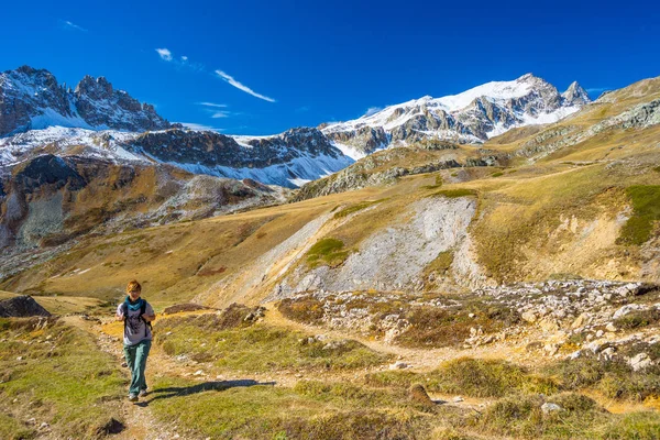 Wandelaar wandelen op een kleurrijke dal met panoramisch uitzicht en levendige kleuren. Groothoek schot in het Italiaanse Franse Alpen. — Stockfoto