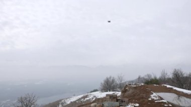 Dağlarda bulut hava, kar uçan uçak. Amaç filme için dron quadcopter ile oynayanlar.