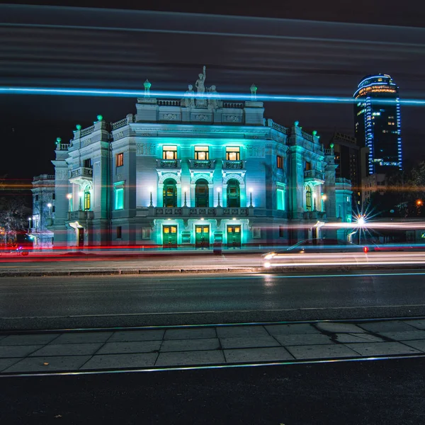 Light trails of passing cars in front of Yekaterinburg Academic Opera and Ballet Theatre at night