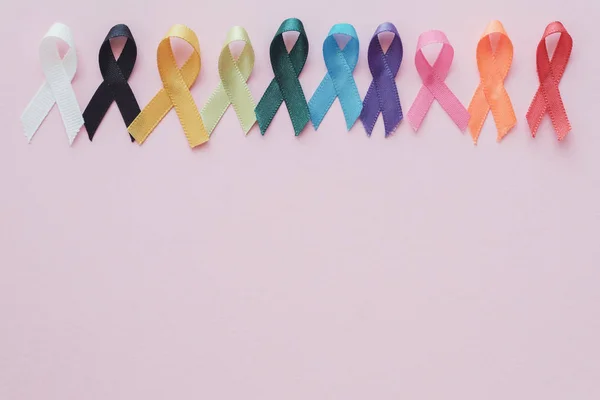 Colorful ribbons on pink background, cancer awareness, World can — Stock Photo, Image