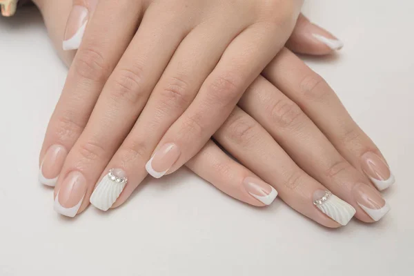 Light manicure in light on a white background. — Stock Photo, Image