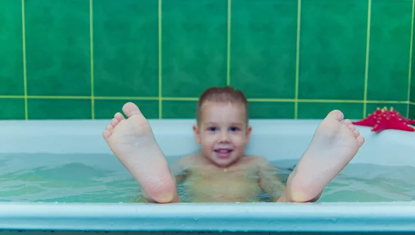 Boy in white bath tub on white background — Stock Photo, Image