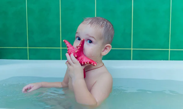 Boy in white bath tub on white background — Stock Photo, Image