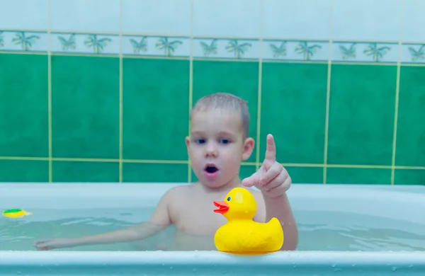 Boy in white bath tub on white background — Stock Photo, Image