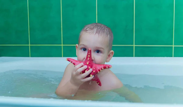 Boy in white bath tub on white background — Stock Photo, Image